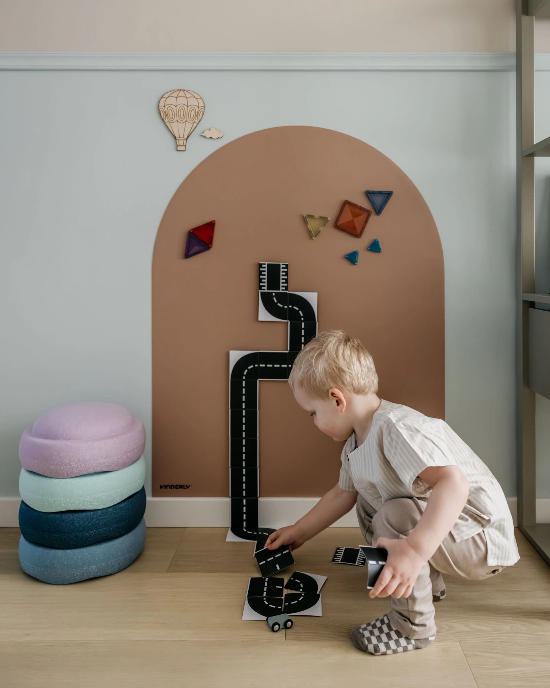 Child arranging Kinderly magnetic alphabet and colour pieces